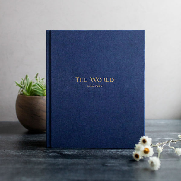 Lifestyle image of The World Travel Stories journal in navy